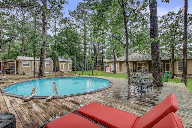 115 Loblolly Ln, Bastrop, TX 78602 - swimming pool with a deck, an outdoor structure, a shed, and outdoor dining area