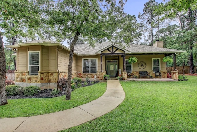 115 Loblolly Ln, Bastrop, TX 78602 - view of front of home with stone siding, a chimney, and a shingled roof