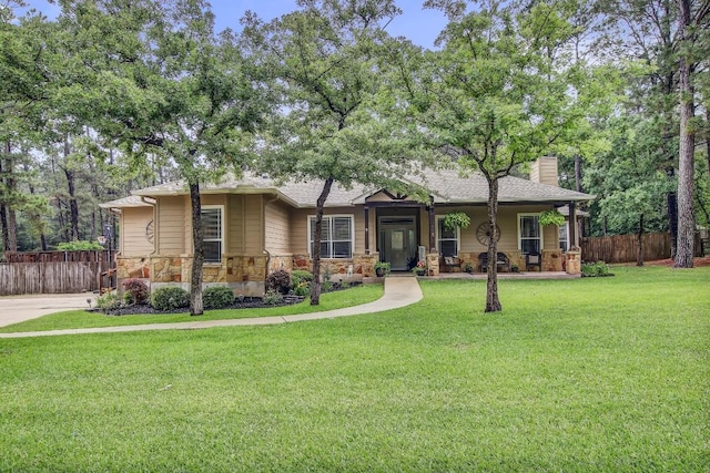 115 Loblolly Ln, Bastrop, TX 78602 - view of front of property featuring stone siding, a chimney, a porch, and a shingled roof