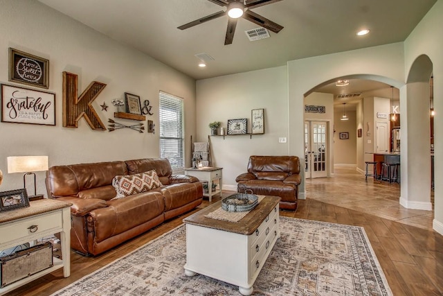 115 Loblolly Ln, Bastrop, TX 78602 - living room with arched walkways, a ceiling fan, wood finished floors, baseboards, and recessed lighting