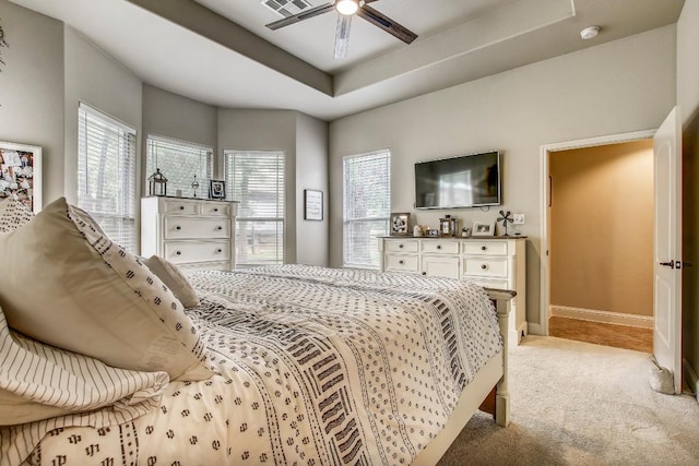115 Loblolly Ln, Bastrop, TX 78602 - bedroom with multiple windows, light colored carpet, baseboards, and a raised ceiling