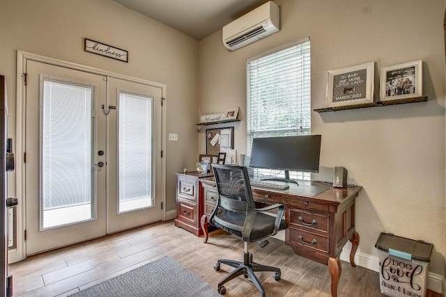 115 Loblolly Ln, Bastrop, TX 78602 - home office with french doors, a wall mounted air conditioner, light wood-style floors, and plenty of natural light