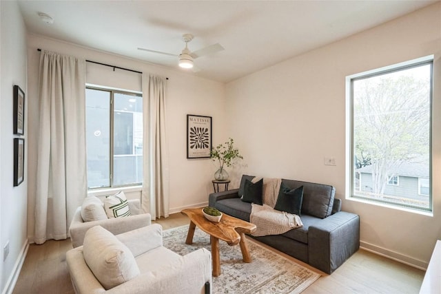 700 Denson Dr Unit 1101, Austin, TX 78752 - living room featuring plenty of natural light, ceiling fan, and baseboards