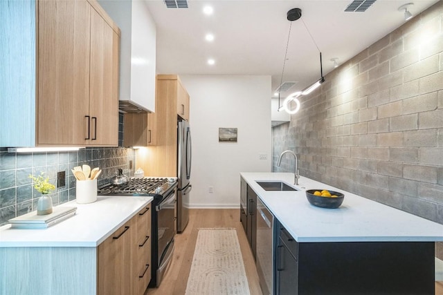 700 Denson Dr Unit 1101, Austin, TX 78752 - kitchen with stainless steel appliances, light brown cabinetry, modern cabinets, decorative backsplash, and recessed lighting