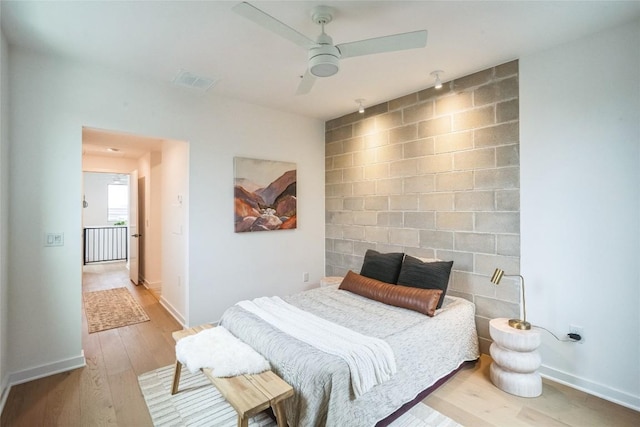 700 Denson Dr Unit 1101, Austin, TX 78752 - bedroom with wood finished floors, baseboards, and a ceiling fan