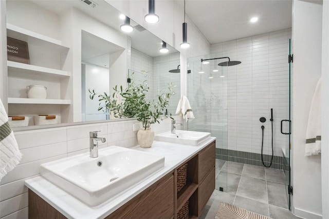 700 Denson Dr Unit 1101, Austin, TX 78752 - bathroom with a stall shower, double vanity, and tile patterned floors