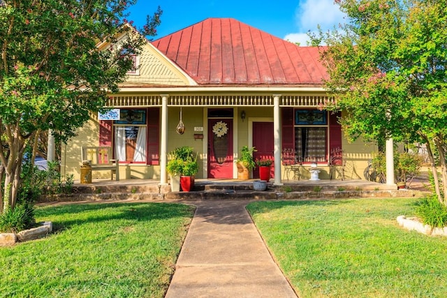 303 Austin St, Fredericksburg, TX 78624 - view of front of property featuring covered porch, a standing seam roof, a front lawn, and metal roof