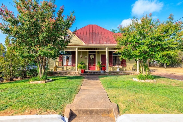 303 Austin St, Fredericksburg, TX 78624 - view of front of property with a standing seam roof, a porch, a front lawn, and metal roof