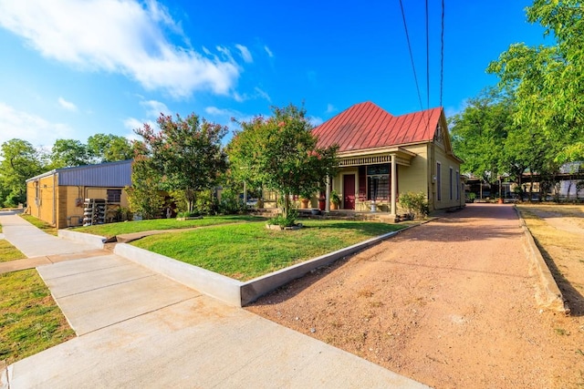 303 Austin St, Fredericksburg, TX 78624 - view of front facade with a front lawn and metal roof
