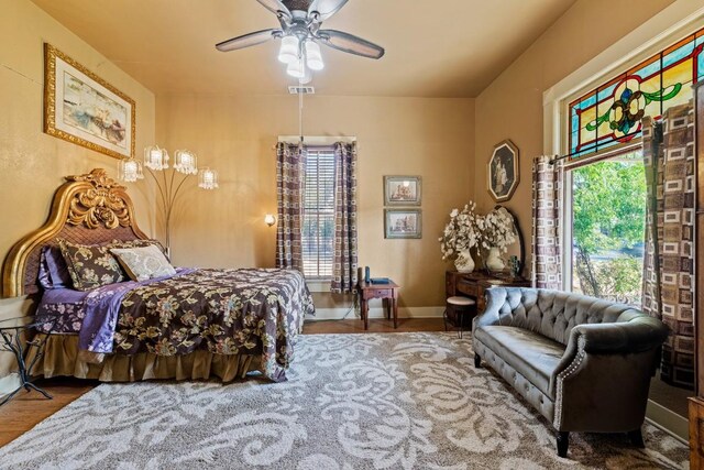 303 Austin St, Fredericksburg, TX 78624 - bedroom with wood finished floors, ceiling fan, and baseboards