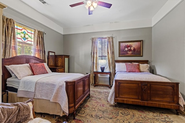 303 Austin St, Fredericksburg, TX 78624 - carpeted bedroom with multiple windows and a ceiling fan