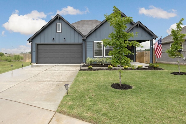 view of front of house with board and batten siding, driveway, a garage, and roof with shingles