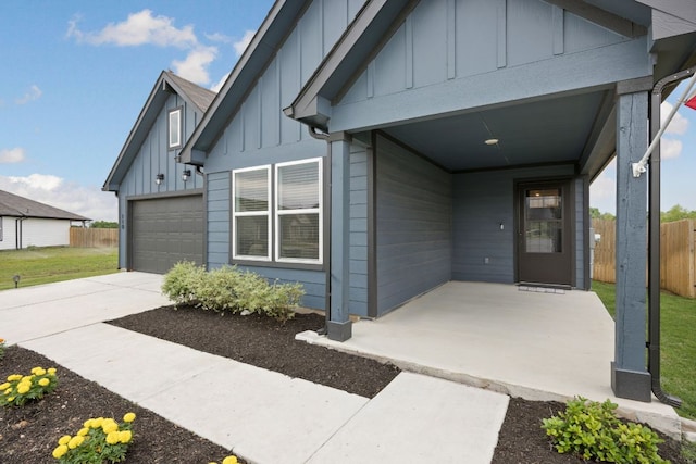 110 Johnson Draw Rd, Hutto, TX 78634 - property entrance featuring board and batten siding, a garage, and concrete driveway