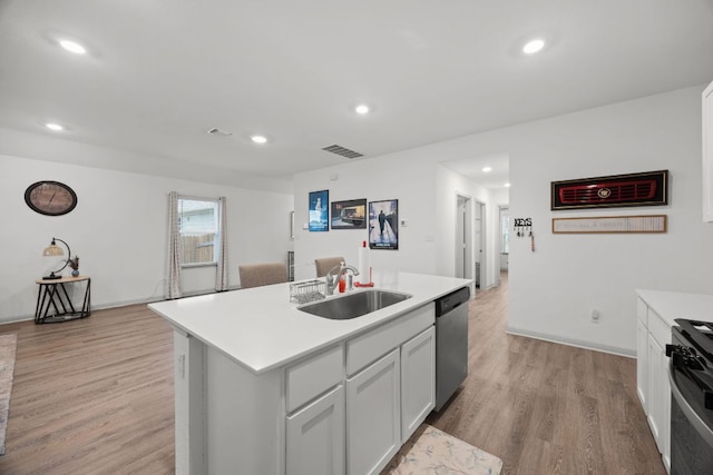 kitchen featuring a sink, stainless steel dishwasher, range, light wood-type flooring, and recessed lighting
