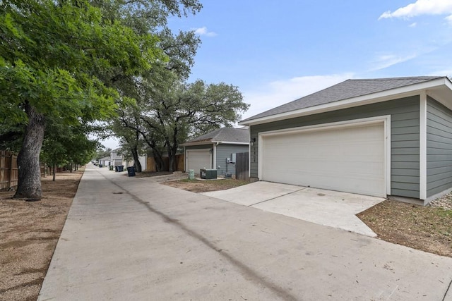 1808 Pecan Island Dr, Leander, TX 78641 - view of side of property with a garage and roof with shingles
