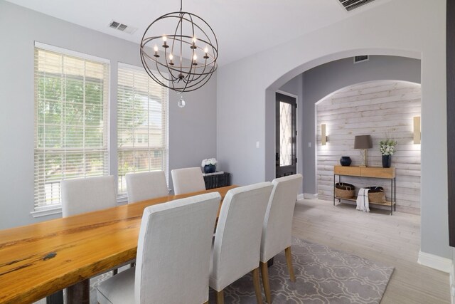 4207 Lazy River Bnd, Cedar Park, TX 78613 - dining room with a chandelier, wood finished floors, and arched walkways