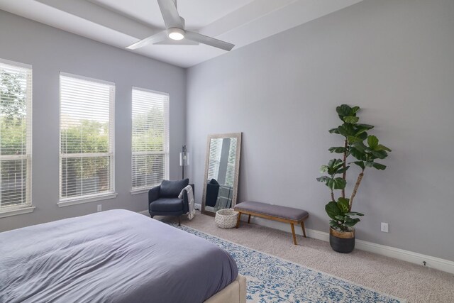 carpeted bedroom with baseboards and ceiling fan