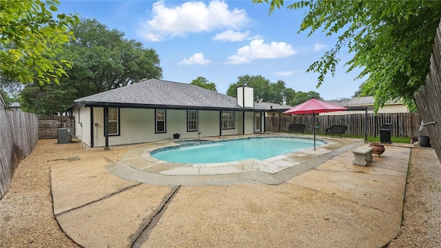 view of pool with central AC, a fenced backyard, a patio, and a pool with connected hot tub