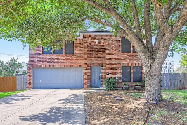 15300 Iola Cv, Austin, TX 78717 - traditional home with concrete driveway, an attached garage, fence, and brick siding