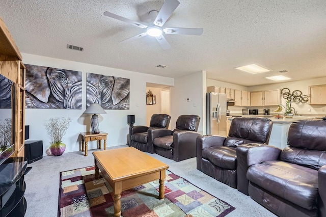15300 Iola Cv, Austin, TX 78717 - living area featuring a textured ceiling, light carpet, and ceiling fan