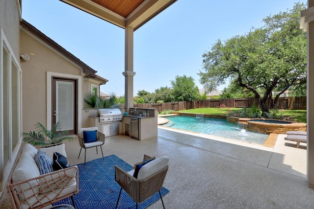 view of pool featuring an outdoor kitchen, grilling area, a fenced backyard, an in-ground hot tub, and a patio area