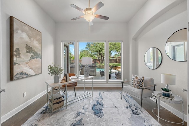 office featuring ceiling fan, wood finished floors, and baseboards