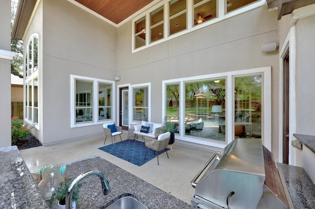 view of patio / terrace featuring a grill and a sink