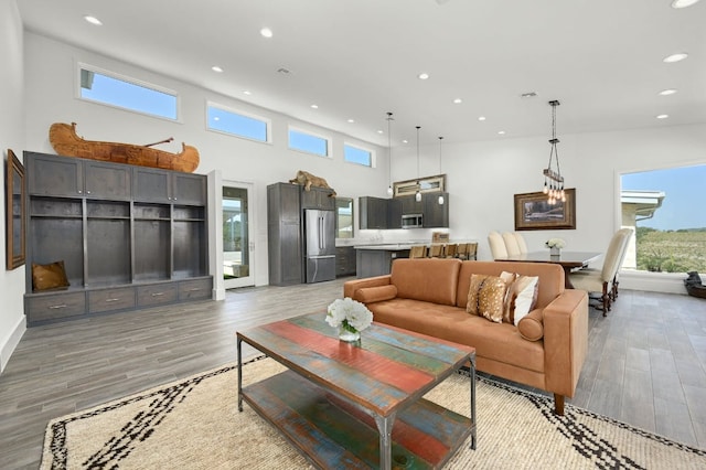 1785 Backbone Rdg, Wimberley, TX 78666 - living area featuring recessed lighting, plenty of natural light, light wood-type flooring, and a towering ceiling