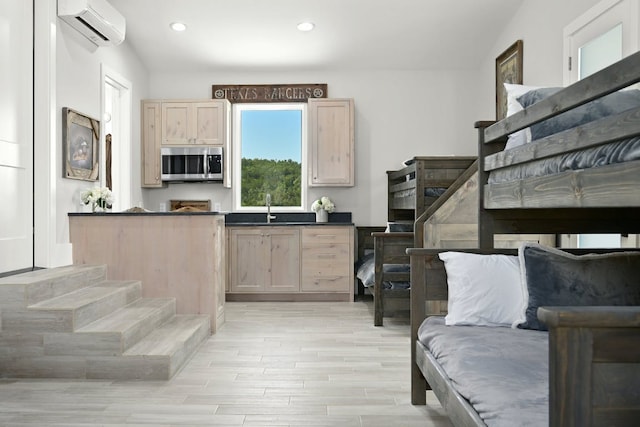 1785 Backbone Rdg, Wimberley, TX 78666 - kitchen featuring stainless steel microwave, a wall unit AC, light brown cabinets, dark countertops, and recessed lighting