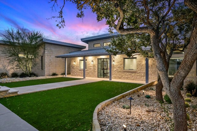 1785 Backbone Rdg, Wimberley, TX 78666 - back of house featuring a lawn, french doors, and stucco siding