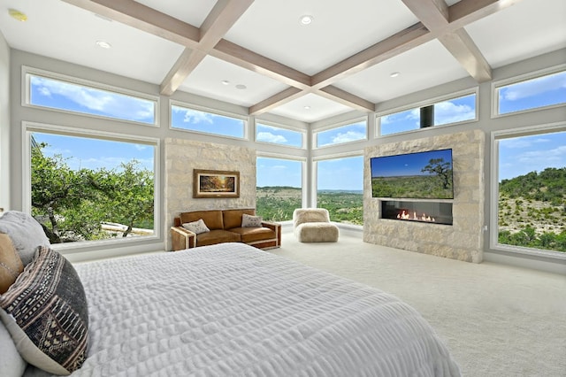 1785 Backbone Rdg, Wimberley, TX 78666 - bedroom with a glass covered fireplace, coffered ceiling, carpet floors, and beamed ceiling