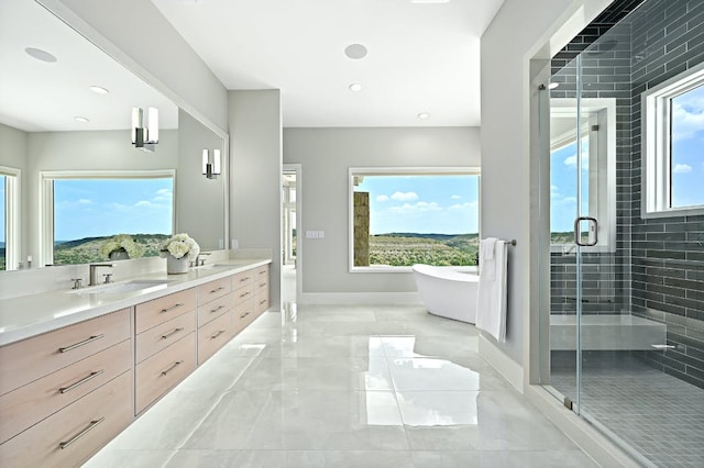 1785 Backbone Rdg, Wimberley, TX 78666 - full bathroom featuring marble tiled floors, double vanity, a shower stall, a soaking tub, and baseboards