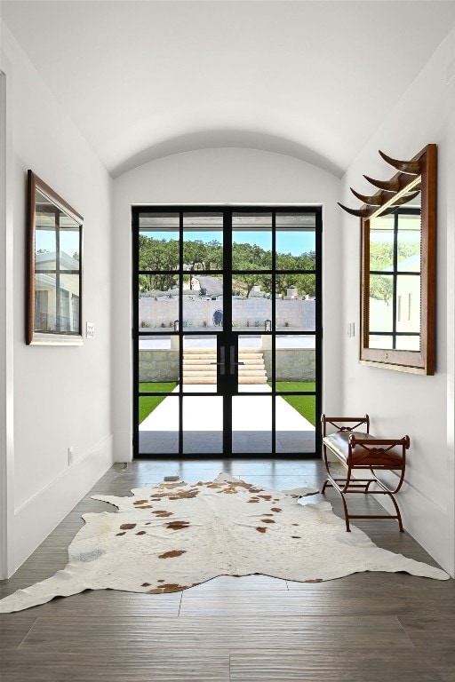 1785 Backbone Rdg, Wimberley, TX 78666 - doorway to outside featuring wood finished floors, baseboards, vaulted ceiling, and french doors