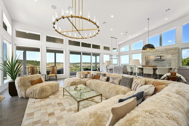 1785 Backbone Rdg, Wimberley, TX 78666 - living area featuring a chandelier, recessed lighting, wood finished floors, and a towering ceiling