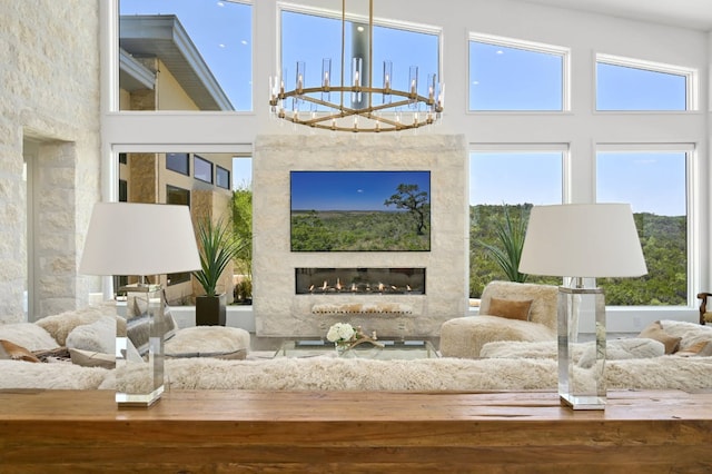 1785 Backbone Rdg, Wimberley, TX 78666 - interior space featuring a chandelier, a glass covered fireplace, and a high ceiling
