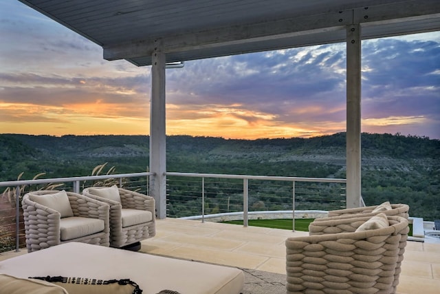 1785 Backbone Rdg, Wimberley, TX 78666 - patio terrace at dusk featuring a balcony and outdoor lounge area