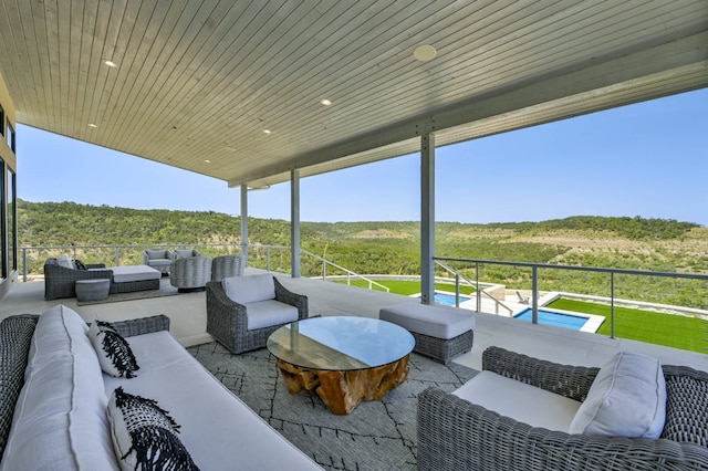1785 Backbone Rdg, Wimberley, TX 78666 - view of patio / terrace with outdoor lounge area, a balcony, and a wooded view