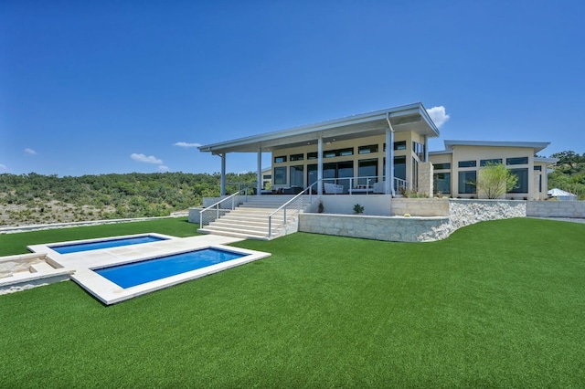 1785 Backbone Rdg, Wimberley, TX 78666 - back of house with a lawn, an outdoor pool, a sunroom, and stairs