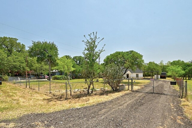 337 Forest Lake Dr, Del Valle, TX 78617 - view of front of home with a gate, driveway, and view of scattered trees
