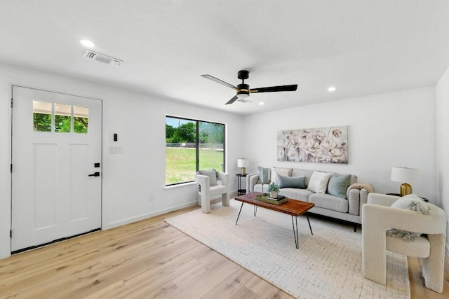 living room featuring wood finished floors, ceiling fan, recessed lighting, and baseboards