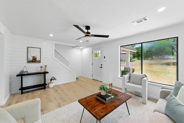 337 Forest Lake Dr, Del Valle, TX 78617 - living area with healthy amount of natural light, wood finished floors, stairway, ceiling fan, and recessed lighting