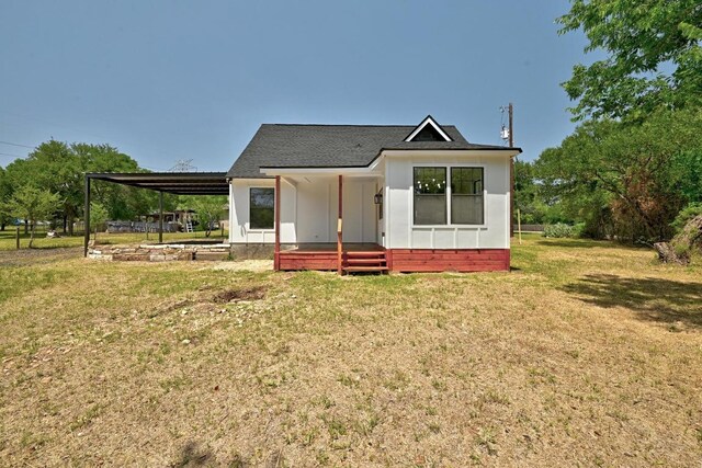 337 Forest Lake Dr, Del Valle, TX 78617 - view of front facade featuring a front yard, a carport, and roof with shingles