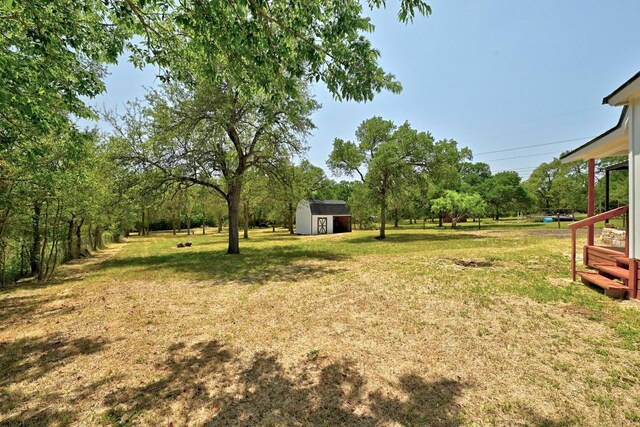 337 Forest Lake Dr, Del Valle, TX 78617 - view of green lawn featuring a storage unit