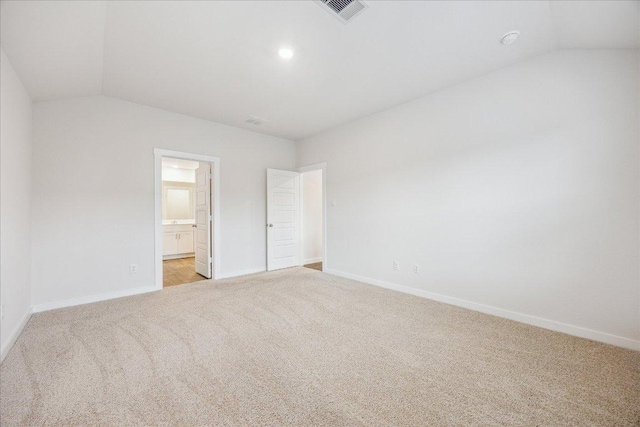 625 Jane Long Dr, San Marcos, TX 78666 - unfurnished bedroom with vaulted ceiling, light colored carpet, baseboards, and ensuite bath