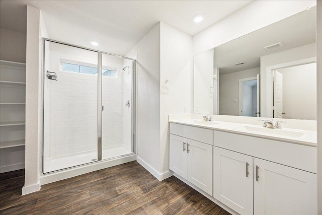 625 Jane Long Dr, San Marcos, TX 78666 - bathroom with a shower stall, double vanity, wood finished floors, baseboards, and recessed lighting