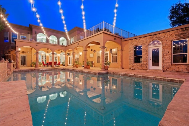 2604 Saratoga Dr, Austin, TX 78733 - pool at night featuring a patio and an outdoor pool