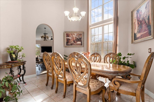 2604 Saratoga Dr, Austin, TX 78733 - dining area featuring a chandelier, a high ceiling, healthy amount of natural light, and baseboards