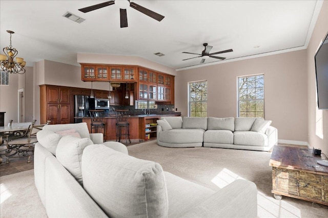 2604 Saratoga Dr, Austin, TX 78733 - living room with ceiling fan, a chandelier, and light carpet