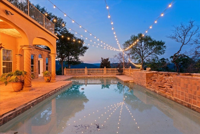 2604 Saratoga Dr, Austin, TX 78733 - pool at dusk featuring a patio