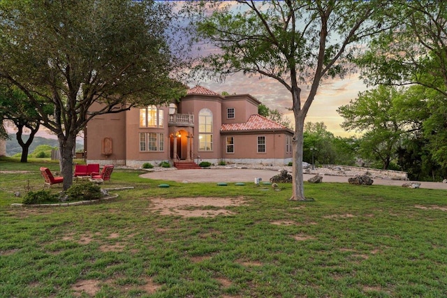 2604 Saratoga Dr, Austin, TX 78733 - mediterranean / spanish-style home with stucco siding, a yard, and a tile roof